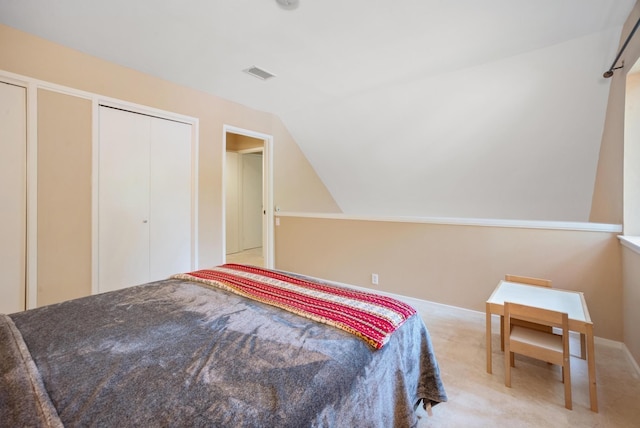 carpeted bedroom with vaulted ceiling