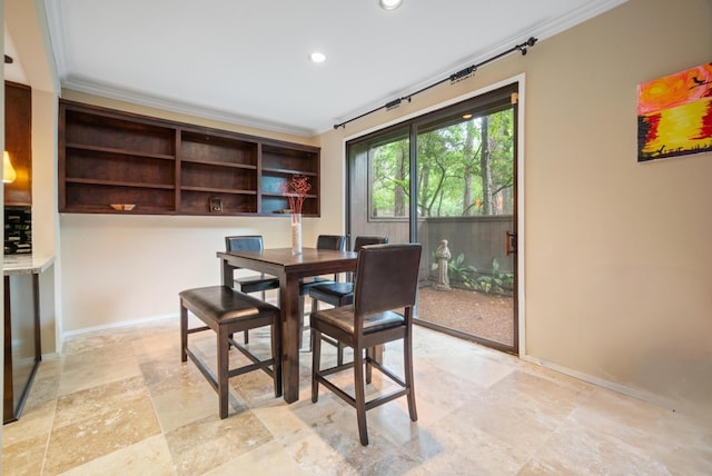 dining area featuring crown molding