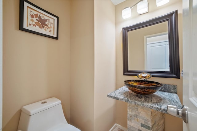 bathroom featuring toilet and sink