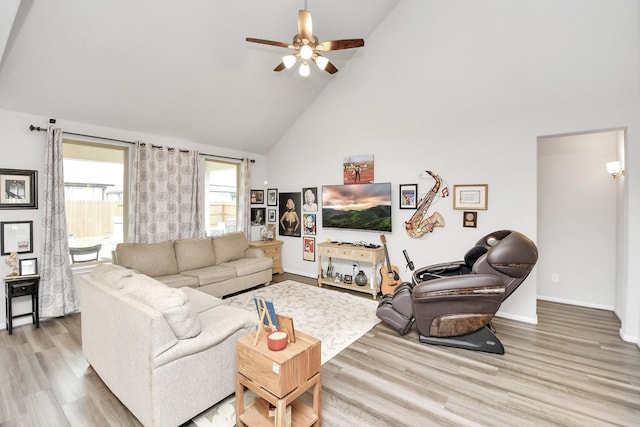 living room featuring ceiling fan, high vaulted ceiling, and hardwood / wood-style flooring