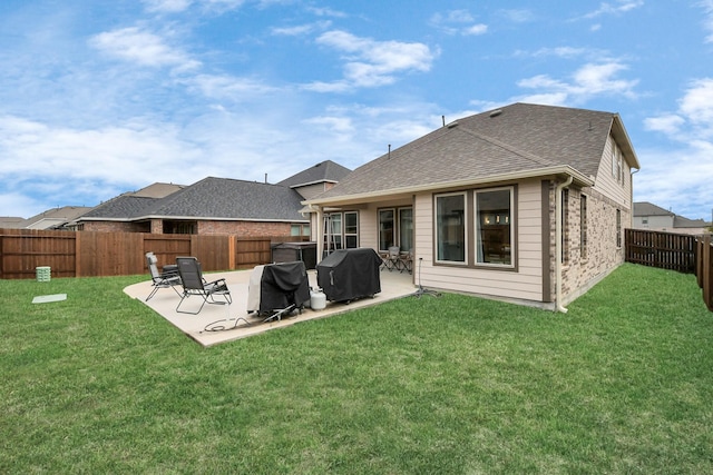 rear view of house featuring a patio area and a lawn