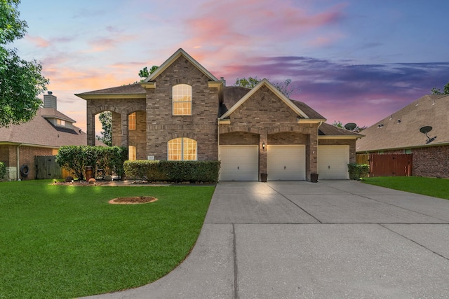 view of front of house featuring a lawn and a garage