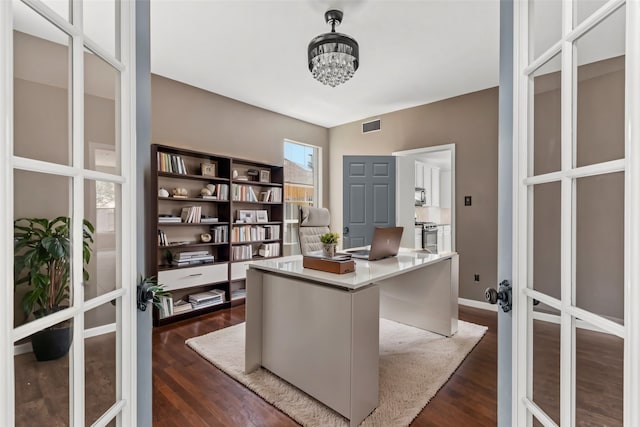 office area featuring dark hardwood / wood-style flooring, french doors, and a notable chandelier