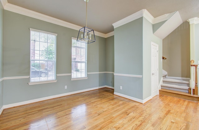 spare room with light hardwood / wood-style floors and crown molding