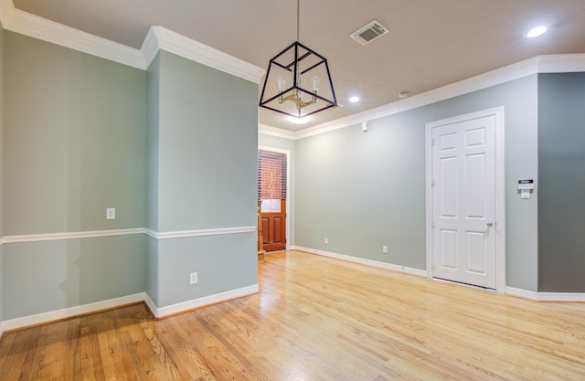 unfurnished room with a chandelier, light hardwood / wood-style flooring, and ornamental molding