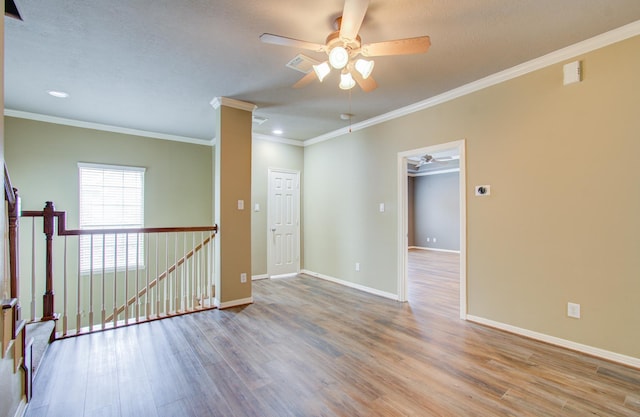 empty room featuring ceiling fan, light hardwood / wood-style floors, and ornamental molding