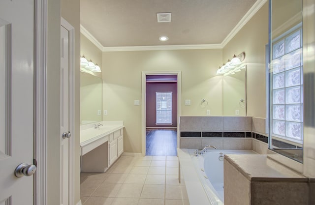 bathroom with tile patterned flooring, vanity, a tub to relax in, and crown molding