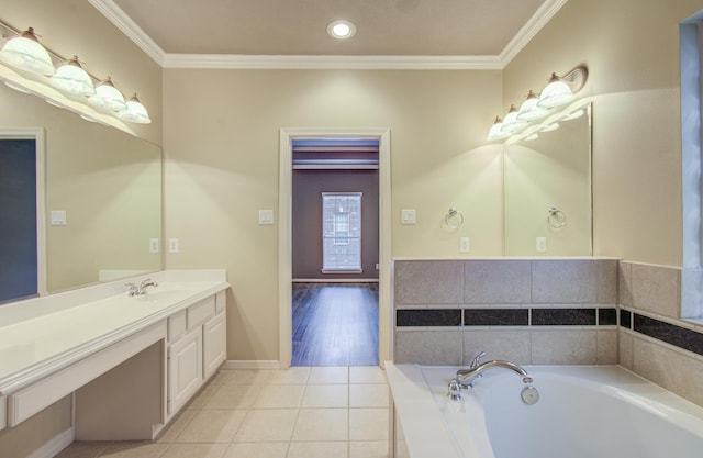 bathroom with tile patterned flooring, vanity, tiled bath, and ornamental molding