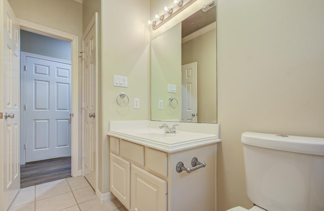 bathroom with tile patterned floors, vanity, and toilet