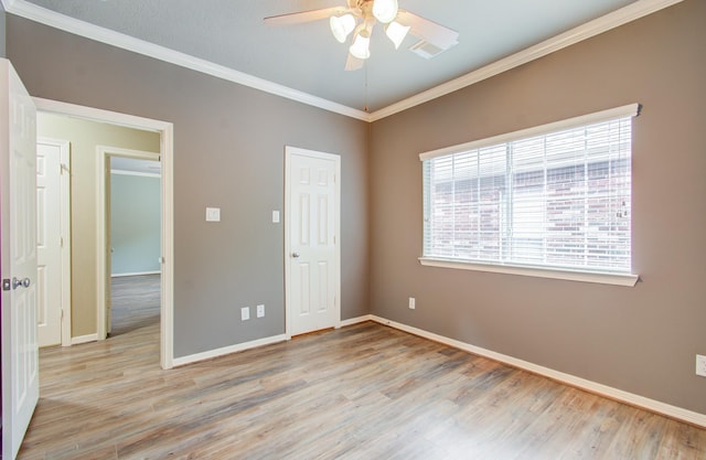 unfurnished bedroom featuring ceiling fan, ornamental molding, and light hardwood / wood-style flooring