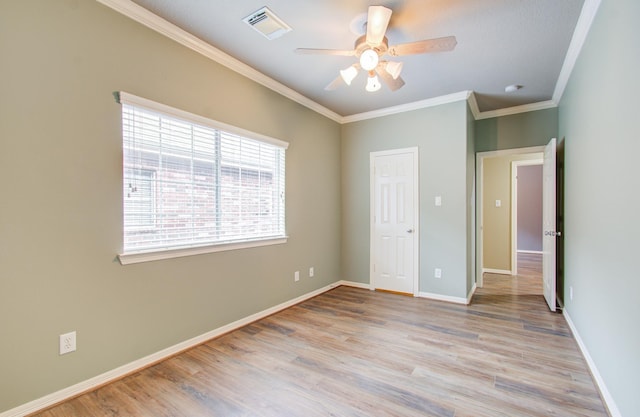 unfurnished bedroom featuring ceiling fan, light wood-type flooring, and ornamental molding