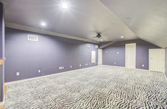 bonus room featuring ceiling fan, light colored carpet, and lofted ceiling