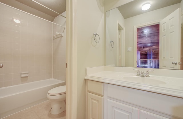 full bathroom featuring tile patterned floors, tiled shower / bath combo, toilet, and vanity