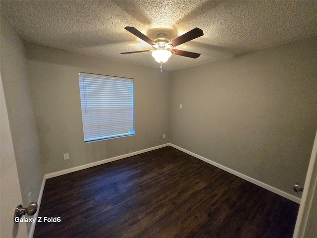 empty room featuring a textured ceiling, dark hardwood / wood-style floors, and ceiling fan