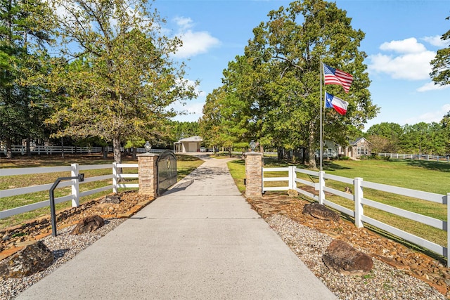 surrounding community with a rural view and a lawn