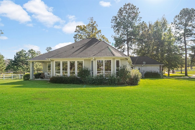 rear view of property with a lawn