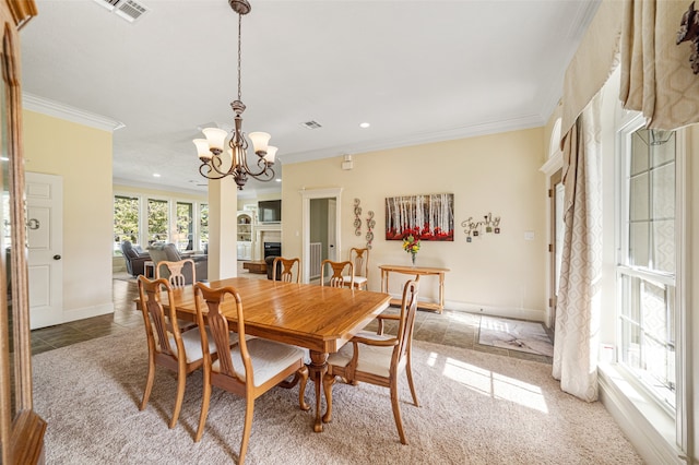 dining area with carpet flooring, a notable chandelier, and ornamental molding