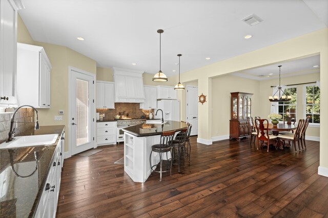 kitchen featuring white cabinetry, an island with sink, and dark hardwood / wood-style floors