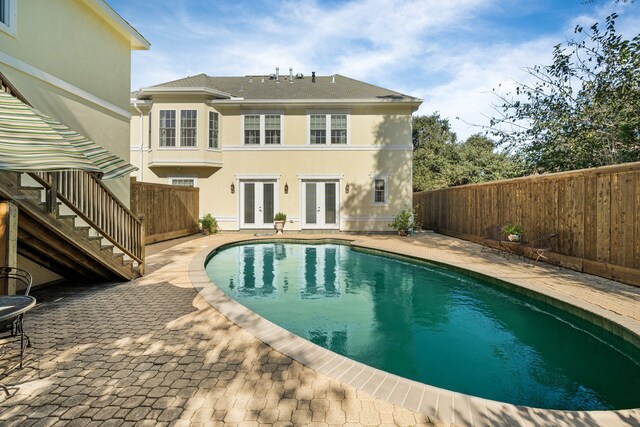 view of pool featuring french doors and a patio area