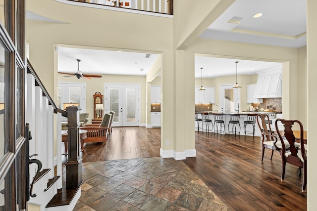 entryway featuring ceiling fan, dark hardwood / wood-style flooring, and french doors