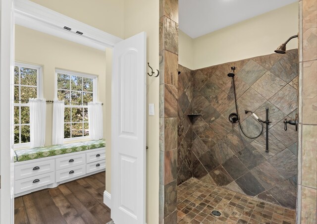 bathroom with a tile shower, vanity, and hardwood / wood-style flooring