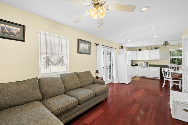 living room featuring dark hardwood / wood-style floors and ceiling fan