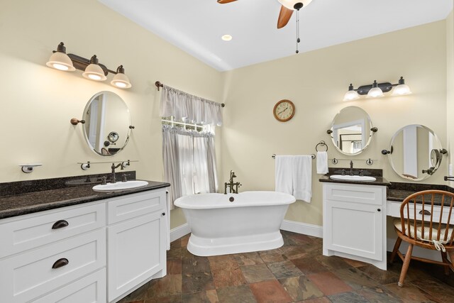 bathroom with vanity, a bathtub, and ceiling fan