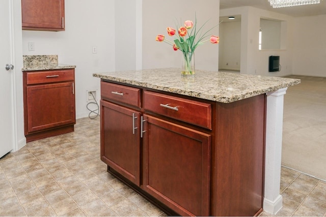 kitchen with light carpet and light stone counters