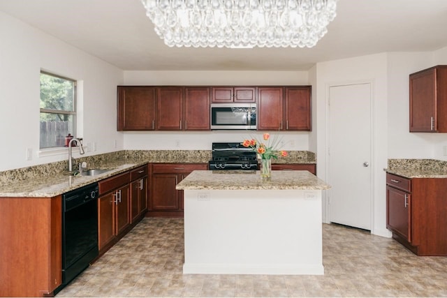 kitchen with sink, a center island, a notable chandelier, and black appliances