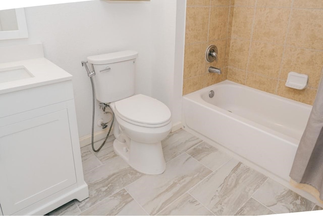 full bathroom with vanity, tiled shower / bath combo, and toilet