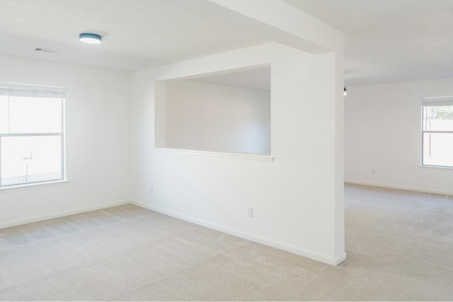 unfurnished room with light carpet