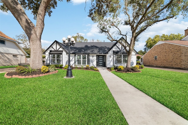 tudor home with a front yard