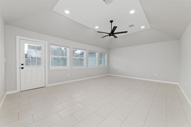 tiled empty room with ceiling fan and vaulted ceiling