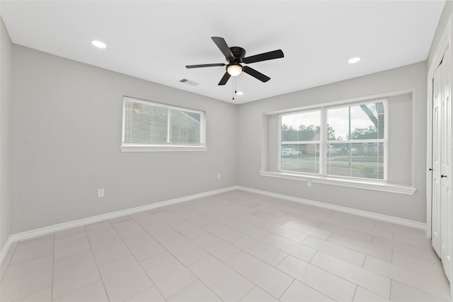 tiled empty room with ceiling fan