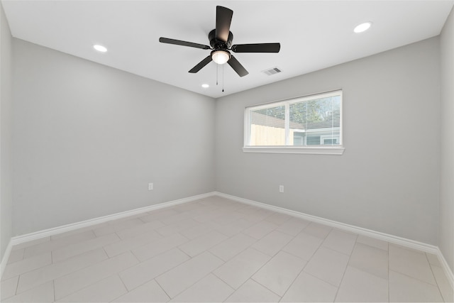 spare room featuring ceiling fan and light tile patterned flooring