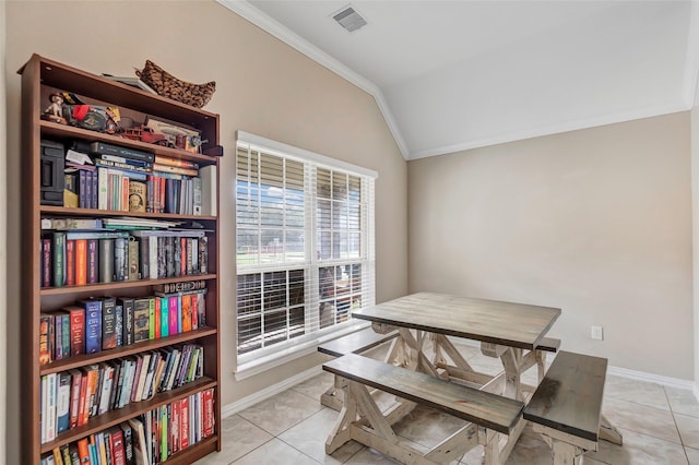 dining room with light tile patterned flooring, ornamental molding, and vaulted ceiling