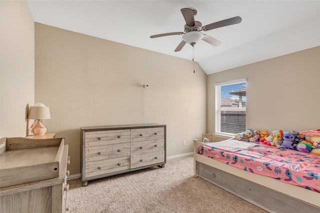 carpeted bedroom with ceiling fan and vaulted ceiling