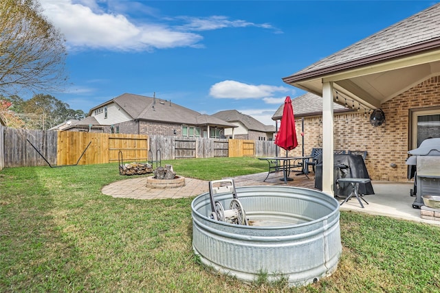 view of yard with a patio and a hot tub