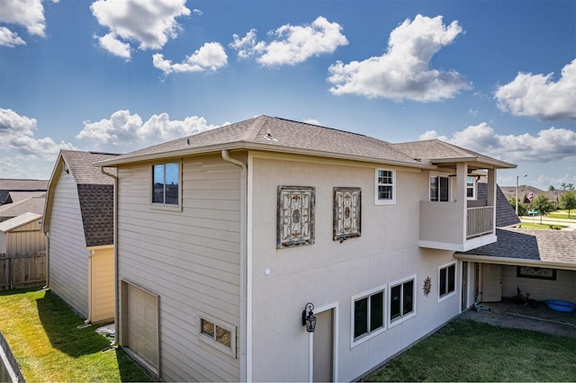 view of side of home featuring a garage and a yard