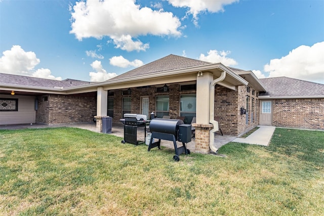 rear view of property with ceiling fan and a lawn