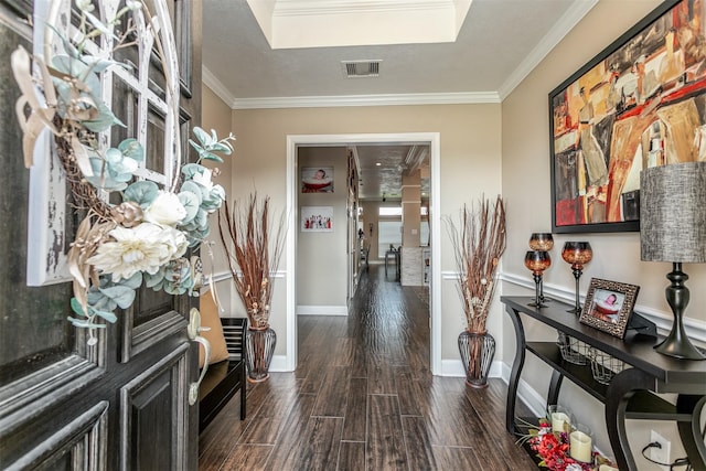 hallway with ornamental molding, a textured ceiling, and dark wood-type flooring