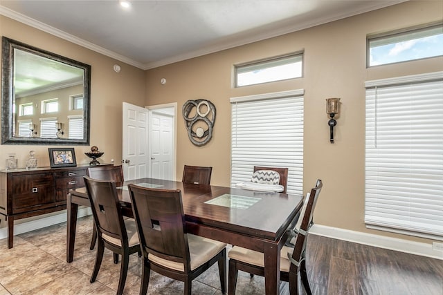 dining space featuring light hardwood / wood-style floors and ornamental molding