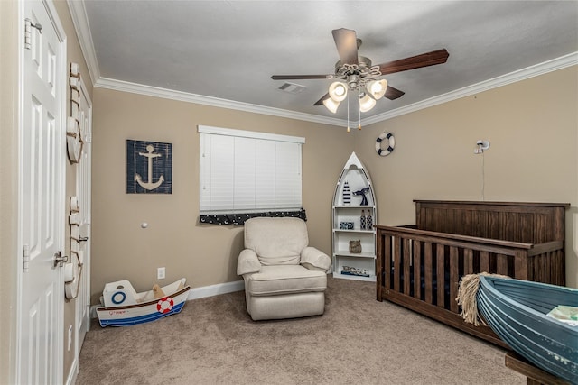 bedroom with carpet, a nursery area, ceiling fan, and ornamental molding