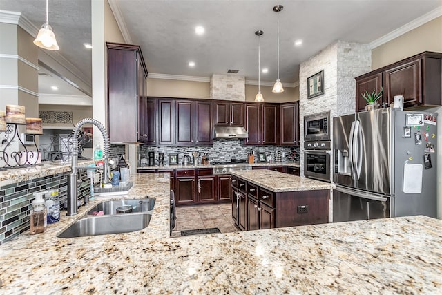 kitchen featuring appliances with stainless steel finishes, hanging light fixtures, ornamental molding, and sink