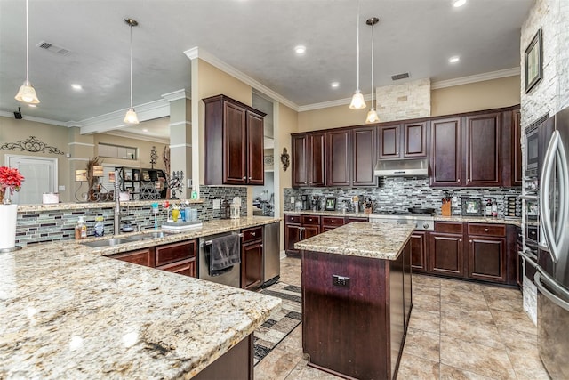 kitchen with sink, a center island, hanging light fixtures, and ornamental molding