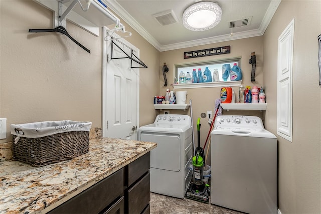 laundry room with separate washer and dryer and crown molding