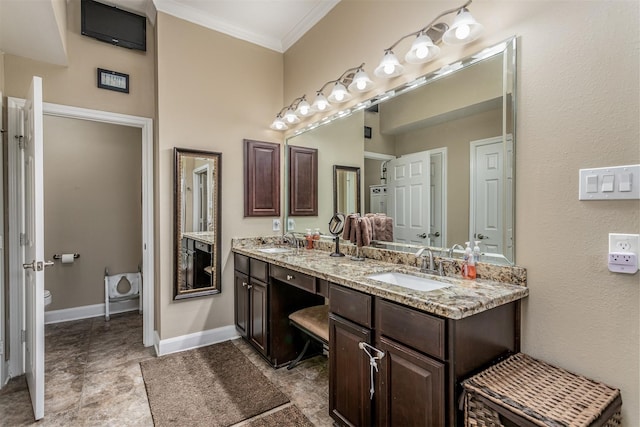 bathroom featuring vanity, toilet, and ornamental molding