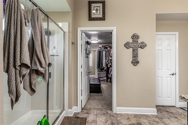 bathroom featuring a shower with door