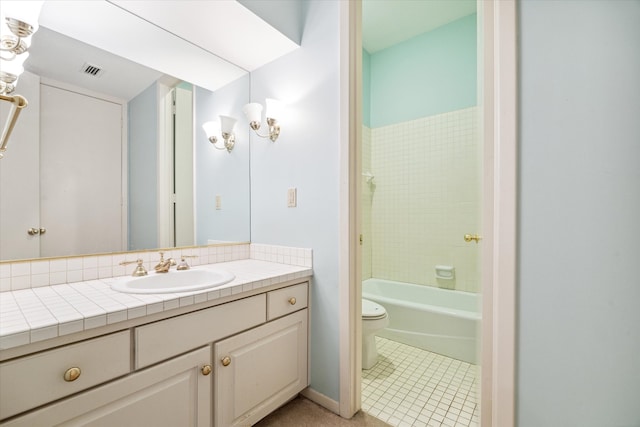 full bathroom with tile patterned flooring, vanity, toilet, and tiled shower / bath combo