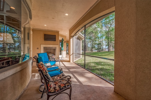 sunroom with an outdoor fireplace